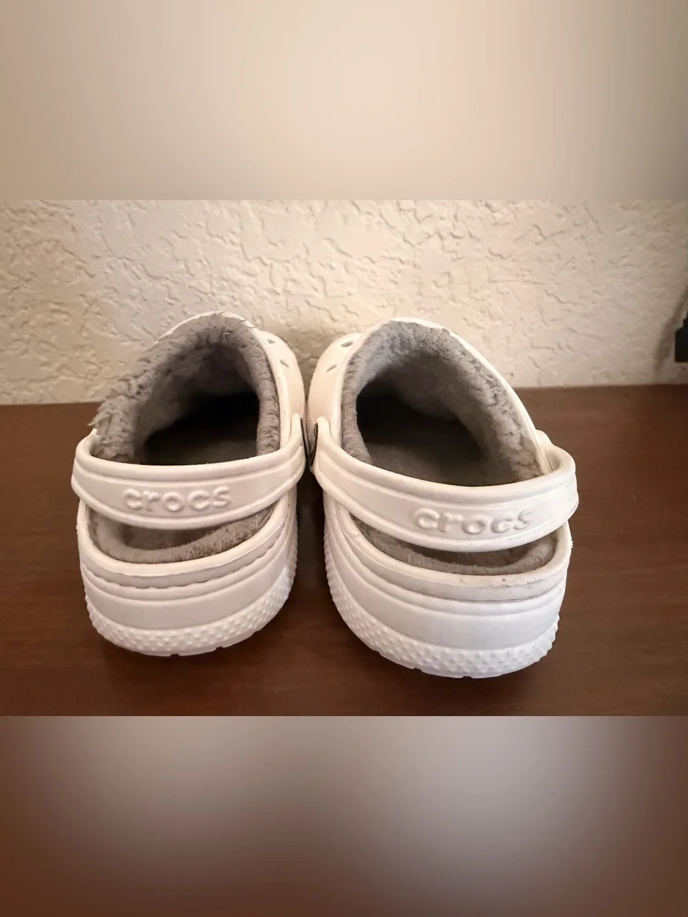 white Crocs Baya Lined Clogs featuring a cozy grey faux-fur lining. C-12